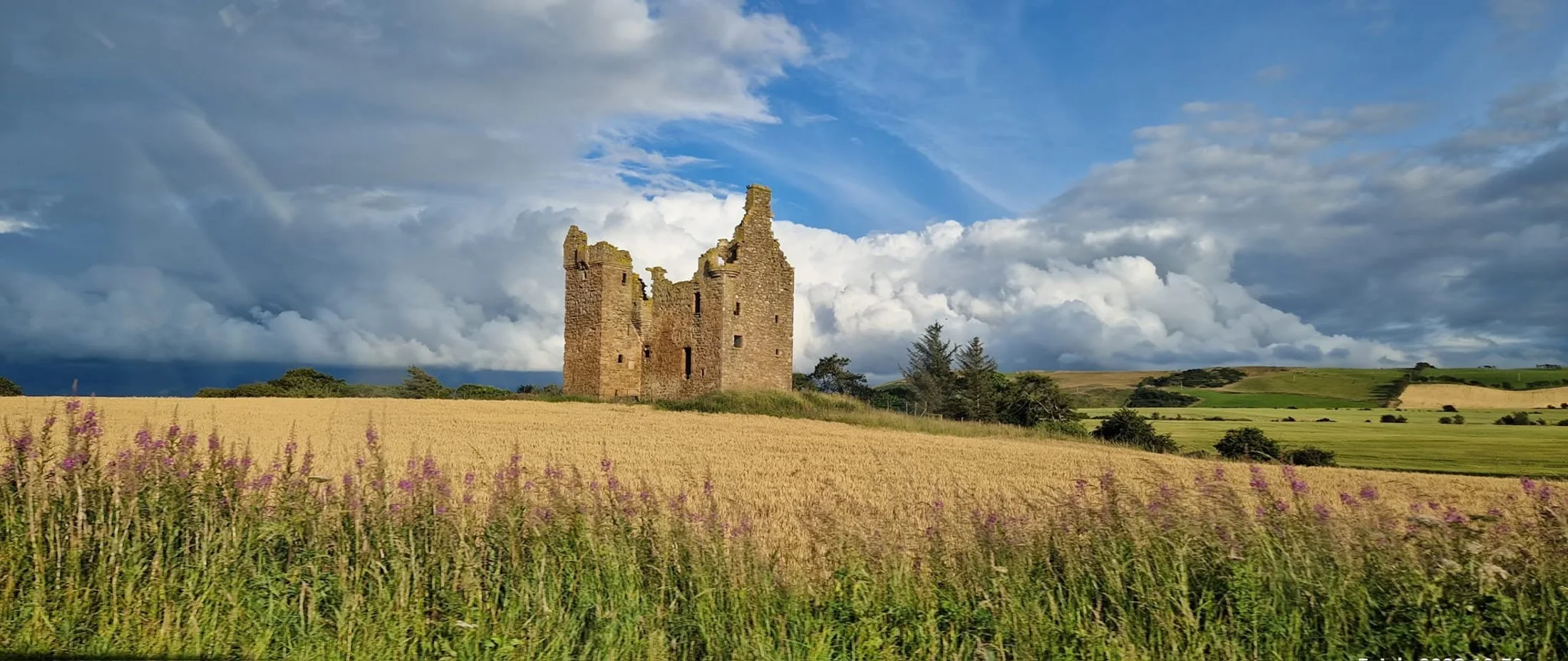 Baltersan Castle standing in Ayrshire fields under a dramatic sky