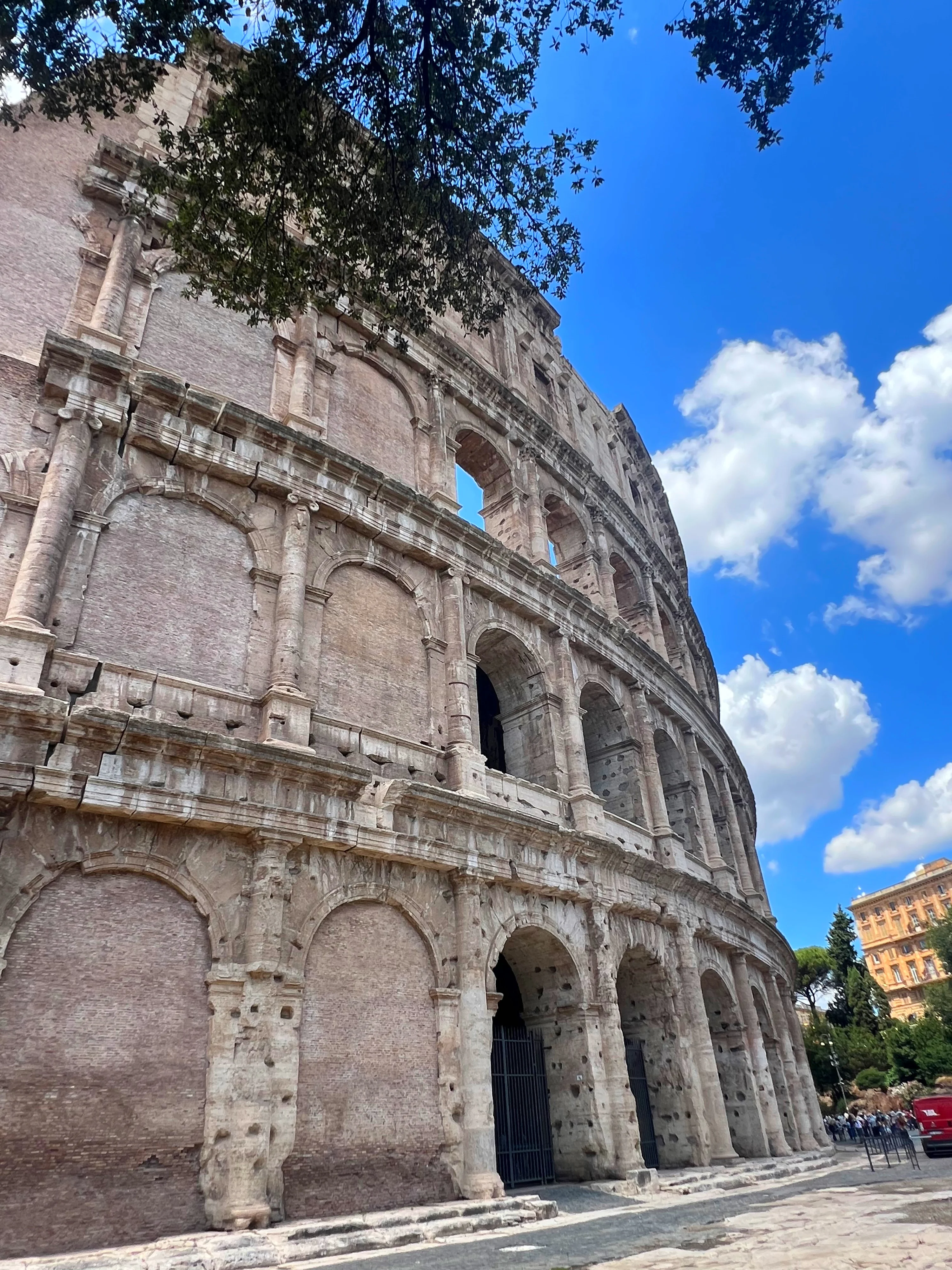 Exterior view of the Colosseum in Rome under bright skies